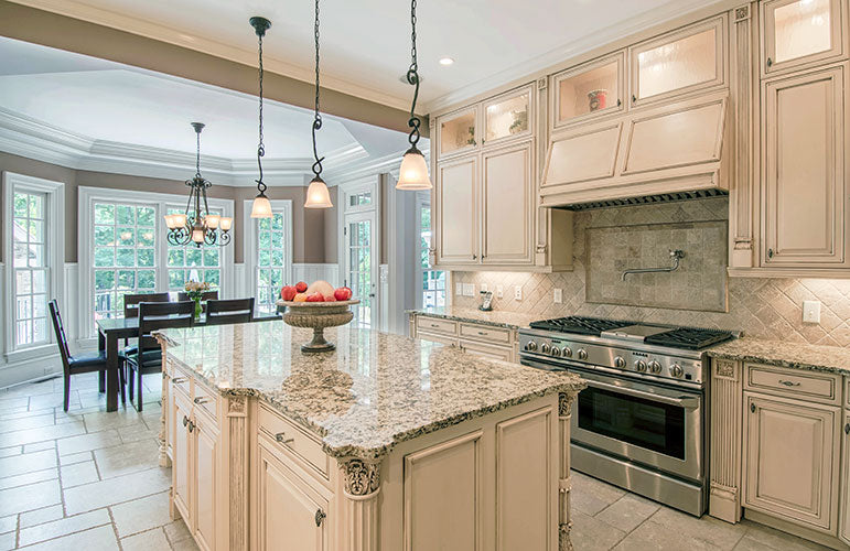 Island with hanging pendant lights above in the kitchen. The Wedgewood plan 806.