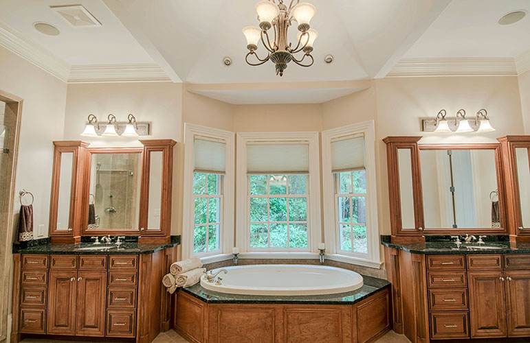 Soaking tub with vanities on either side in the master bathroom. The Wedgewood plan 806.