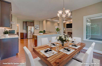 Chandelier in the dining room with view to the kitchen. The Westlake plan 1332.