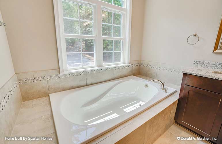 Sitting tub with windows above in the master bathroom. The Westlake plan 1332.