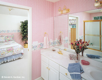 Pink wall paper and double sink vanity in the master bathroom. The Westport plan 389.