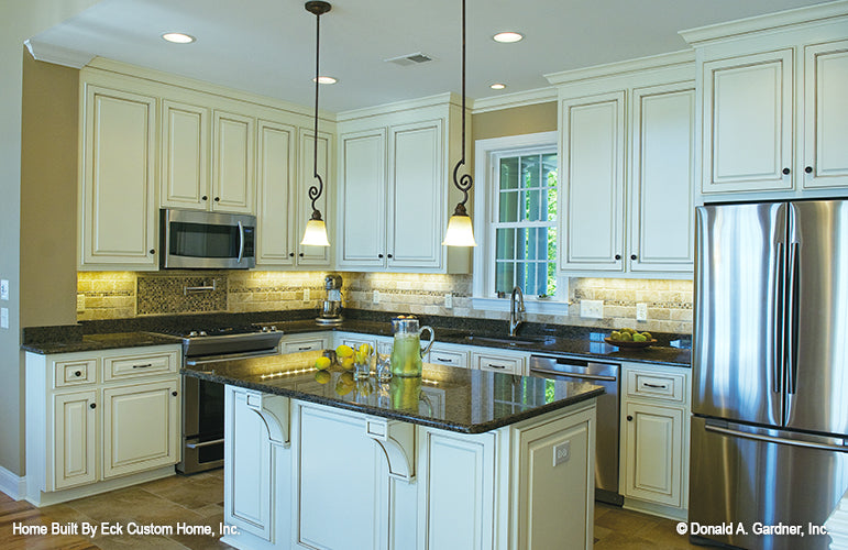 Recessed lighting and island in the kitchen.  The Whitcomb plan 1218.