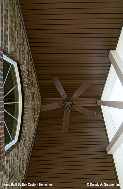 Outdoor ceiling fan in the vaulted ceiling in the rear porch.  The Whitcomb plan 1218.