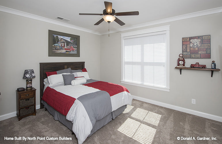 Crown molding around the ceiling and window in the secondary bedroom. The Wilkerson plan 1296.