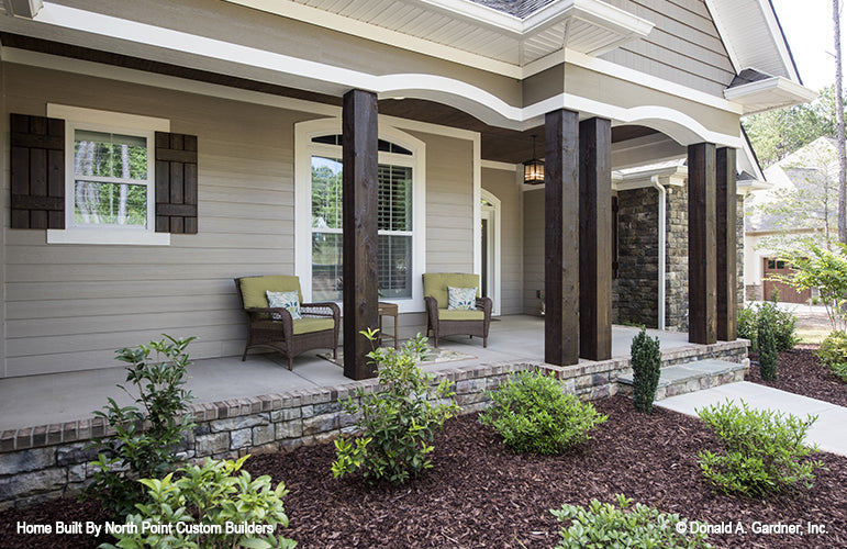 Covered front porch with stained wood columns. The Wilkerson plan 1296. 