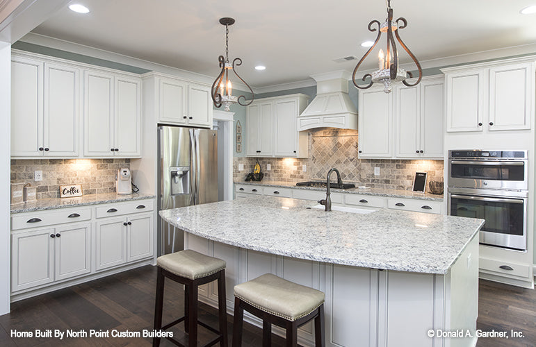 Pendant lighting over the kitchen island. The Wilkerson plan 1296.