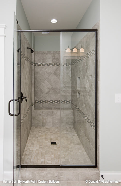 Tiled walk-in shower in the master bathroom. The Wilkerson plan 1296.