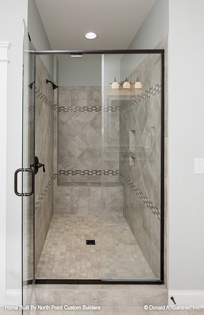 Tiled walk-in shower in the master bathroom. The Wilkerson plan 1296.