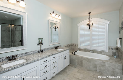 Double sink vanity and sitting tub in the master bathroom. The Wilkerson plan 1296.