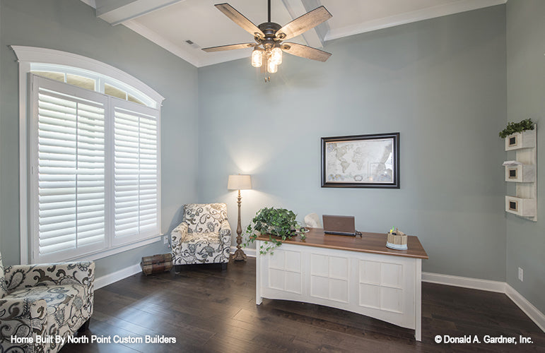 Arched window and ceiling fan in the study. The Wilkerson plan 1296.