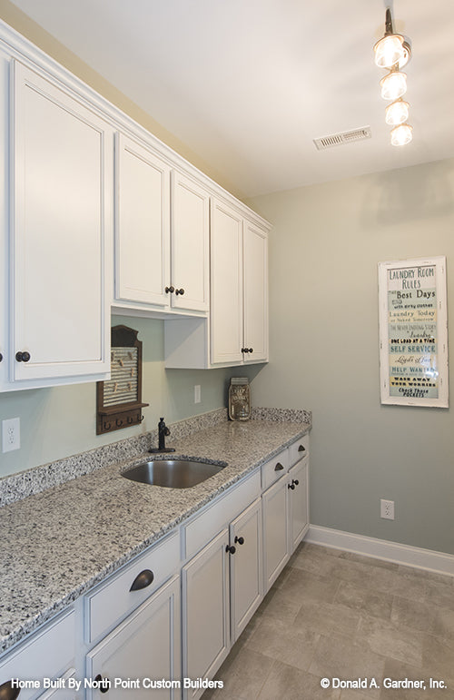 Cabinets and sink in the utility room. The Wilkerson plan 1296.