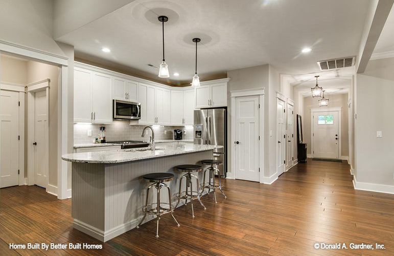 Kitchen island with a sink and seating. The Williamette plan 1203.