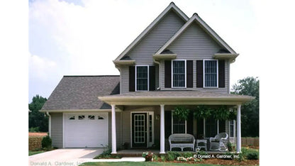 Front view two story home with a front facing garage. Photograph submitted by the customer. The Willowbrook plan 453.