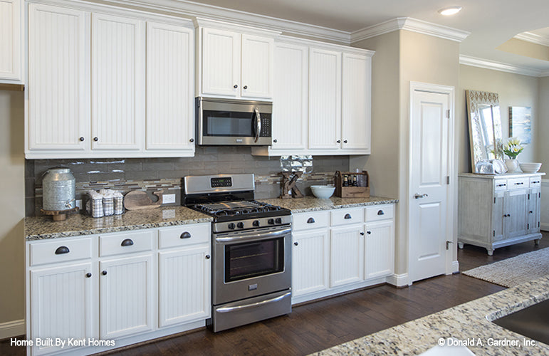 White cabinets in the kitchen. The Wilton plan 981.