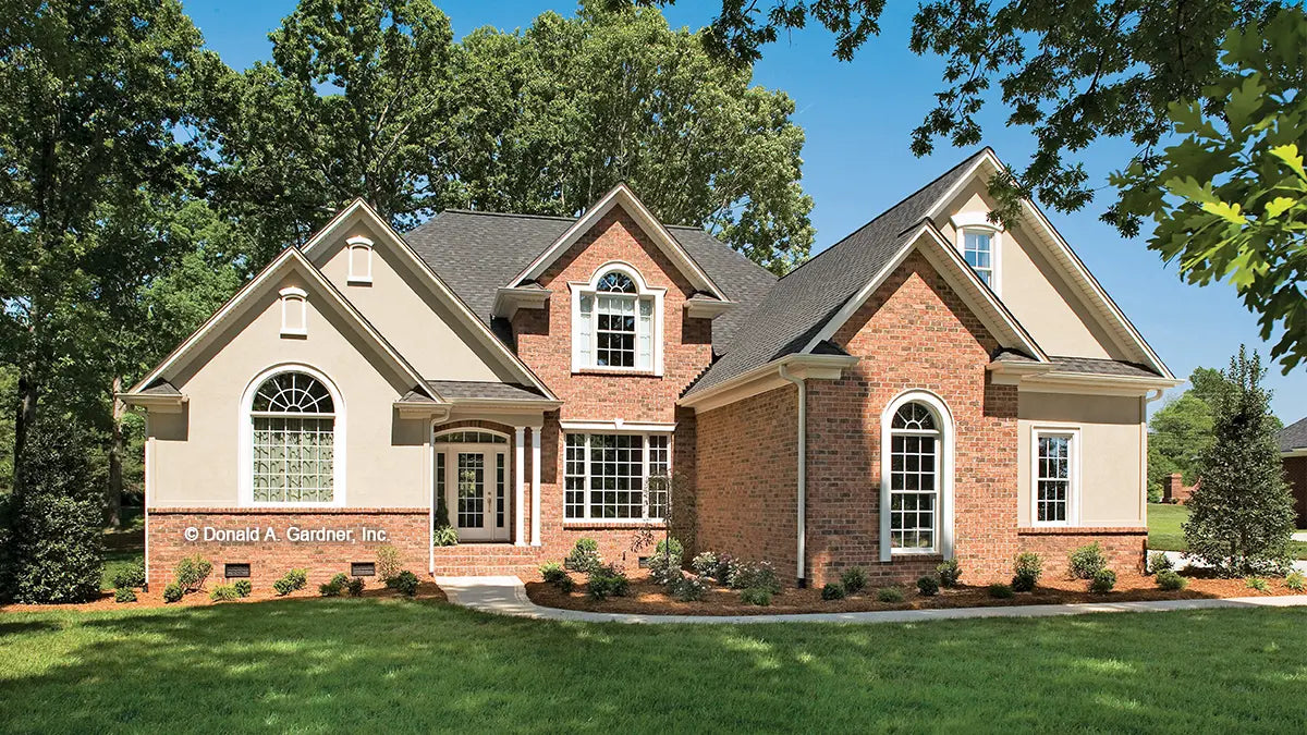 Photographs are submitted by the customer. Front view of a brick and stucco age. The Winslow plan 903.