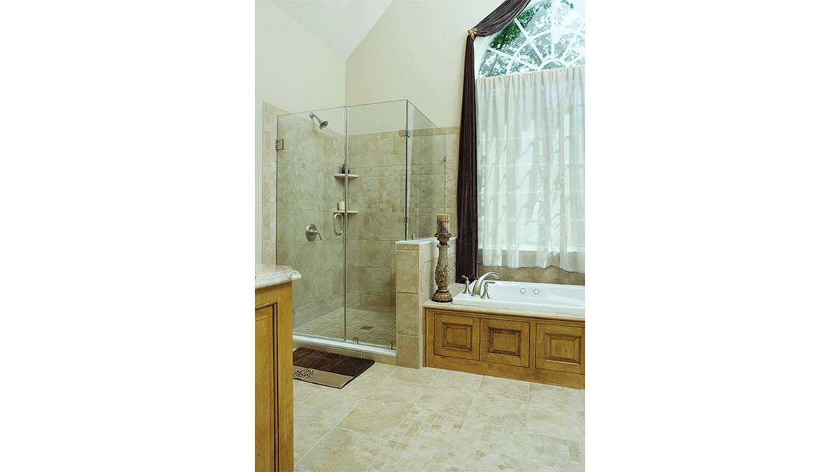 Glass walk-in shower next to the soaking tub in the master bathroom. The Winslow plan 903.