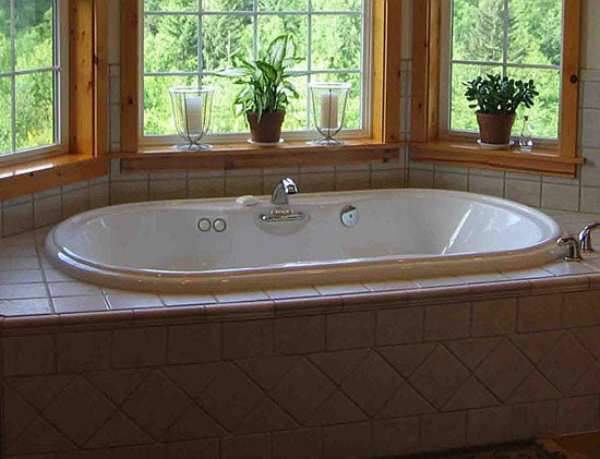 Windows around the soaking tub in the master bathroom. The Woodland plan 256.