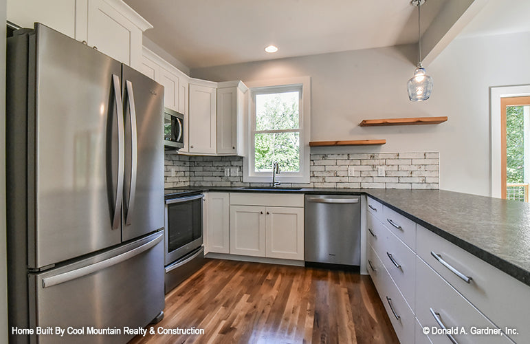 Kitchen with wrap around counter space and window above the sink. The Wycliff plan