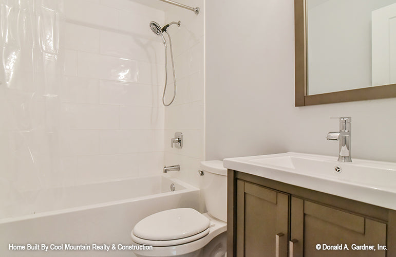 Bathroom with single sink vanity and shower tub combo. The Wycliff plan