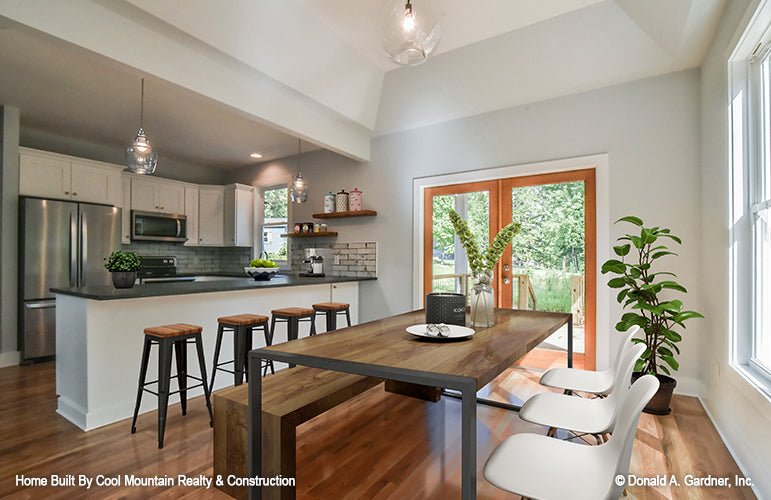 Open dining room with view into the kitchen, French doors leading to deck. The Wycliff plan