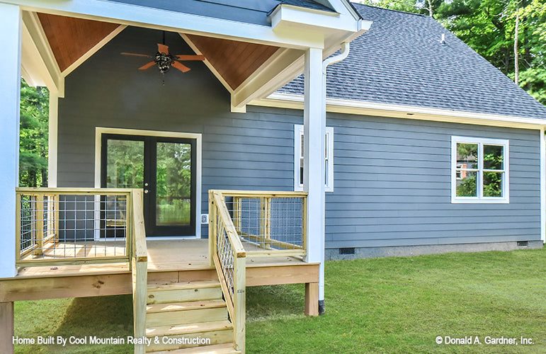 Cozy rear deck with vaulted ceiling and outdoor ceiling fan. The Wycliff plan