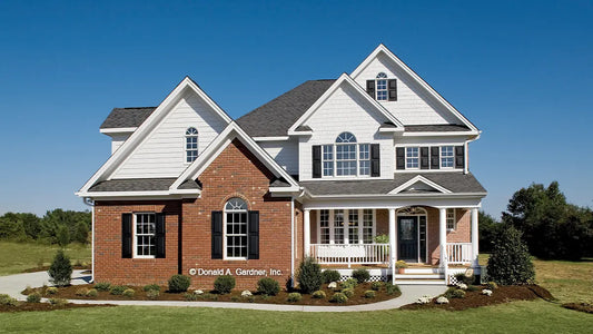 This is a photograph submitted by the customer. Front view two story home with a covered front porch. The Yarborough plan 964.