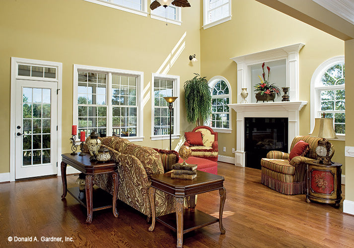 Wood floors and fireplace in the great room. The Yarborough plan 964.