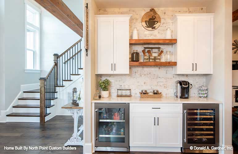 White cabinets at the coffee bar in the kitchen. The Zander plan 1478.