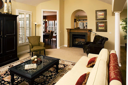 Fireplace with an arched window cut out above in the great room. The Zeller plan 1014.