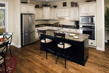 Wood floors and white cabinets in the kitchen. The Zeller plan 1014.