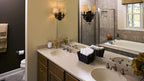 Double sink vanity with a wall separating the toilet area in the master bathroom. The Zeller plan 1014.