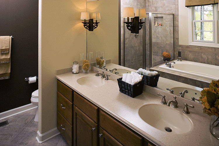 Double sink vanity with a wall separating the toilet area in the master bathroom. The Zeller plan 1014.