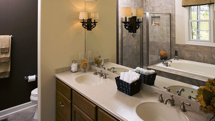 Double sink vanity with a wall separating the toilet area in the master bathroom. The Zeller plan 1014.